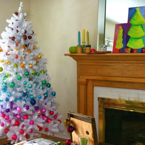 brilliant-christmas-decoration-trends-on-white-artificial-tree-with-different-color-of-glitter-balls-ornament-near-indoor-fireplace